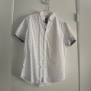 Small white button up shirt with red flamingos